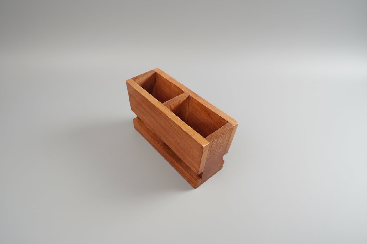 A stylish 2-compartment wooden cutlery holder with a raised base—designed to organize beautifully and elevate your table setting.