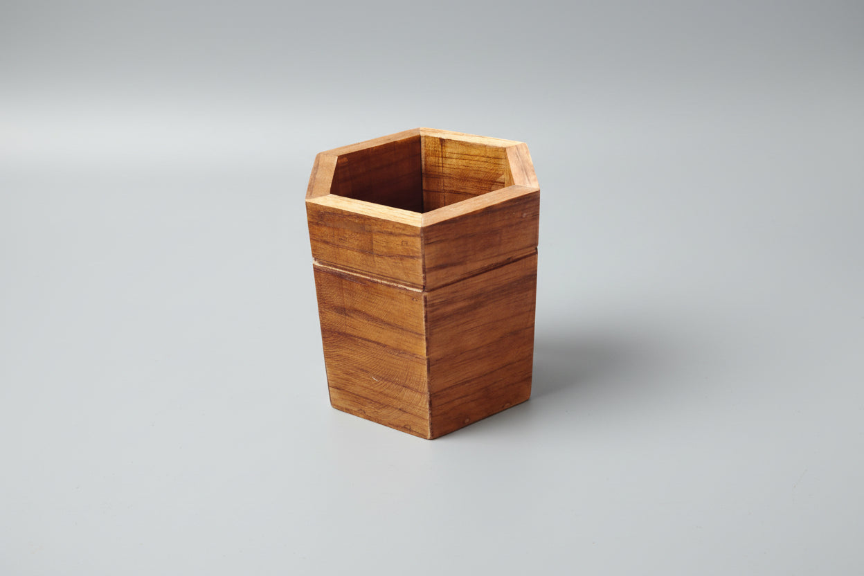 Hexagonal wooden container on a white background