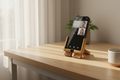 Foldable wooden phone stand for desk, video calls, and media viewing.
