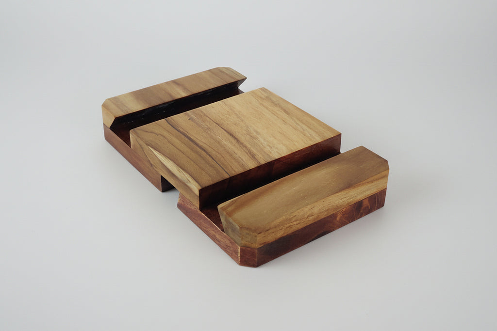 Minimalist wooden 3-way phone stand for desk, video calls, and media viewing.