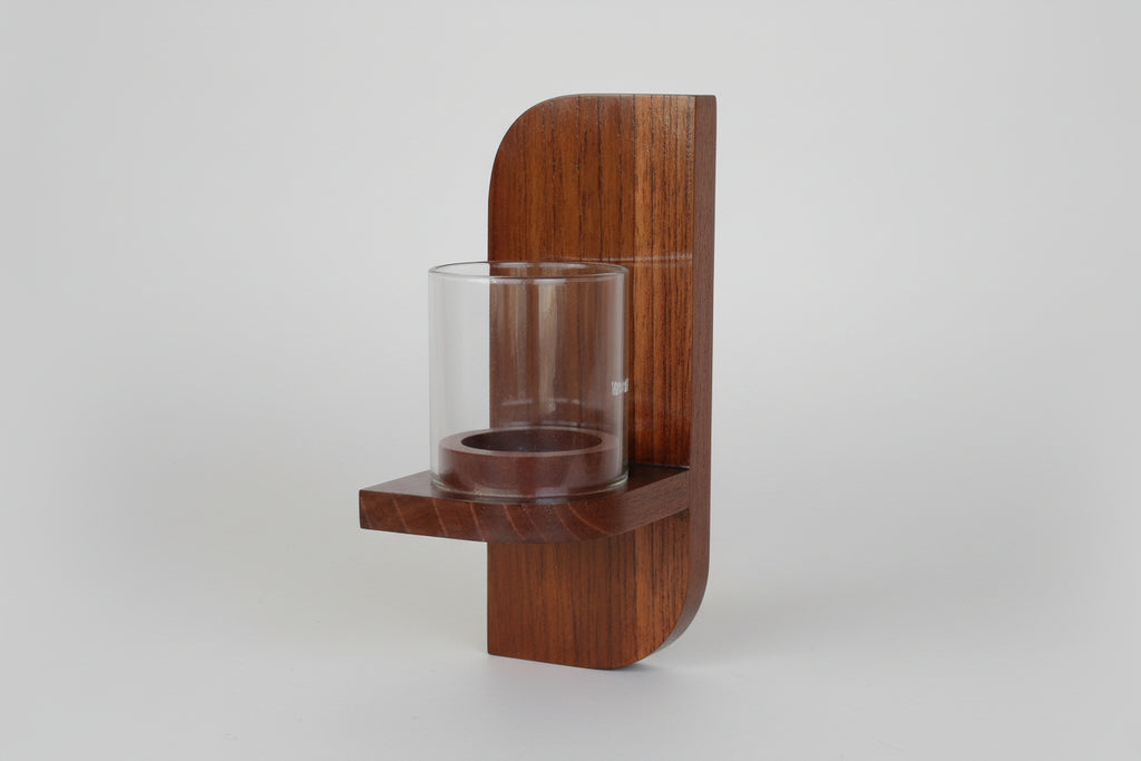 Rectangular wall-mounted wooden candle holder for warm ambient lighting.