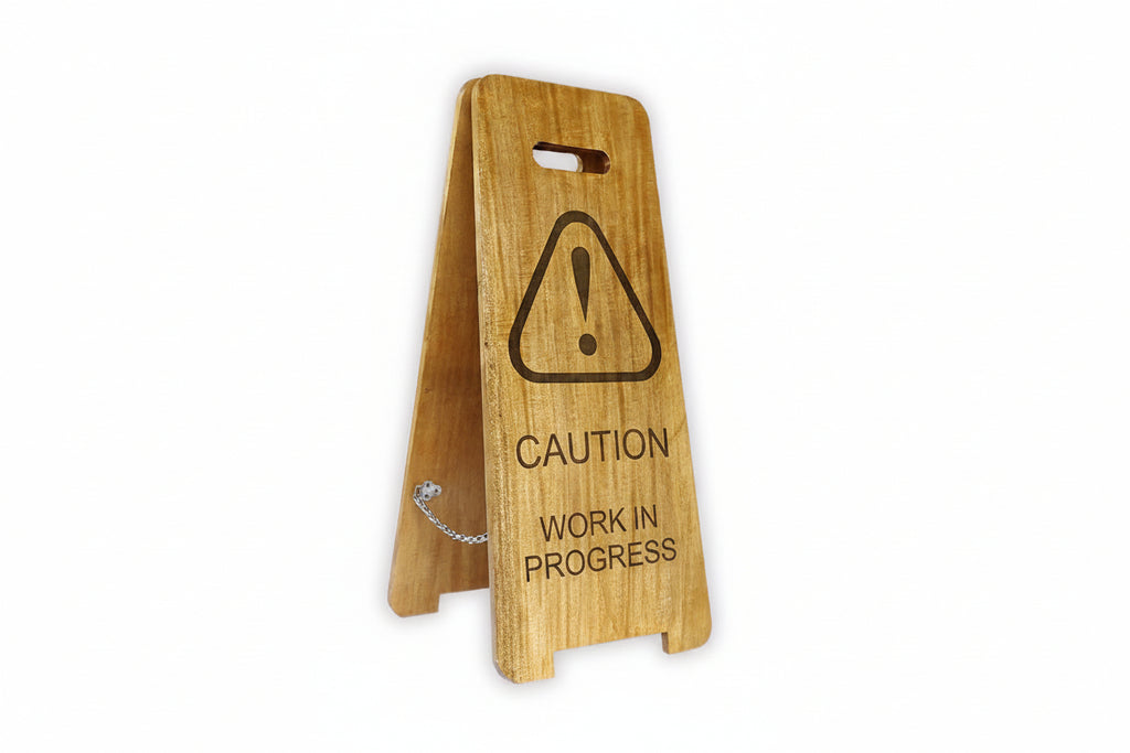Wooden sign with caution symbol and text on a white background