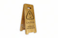 Wooden sign with caution symbol and text on a white background